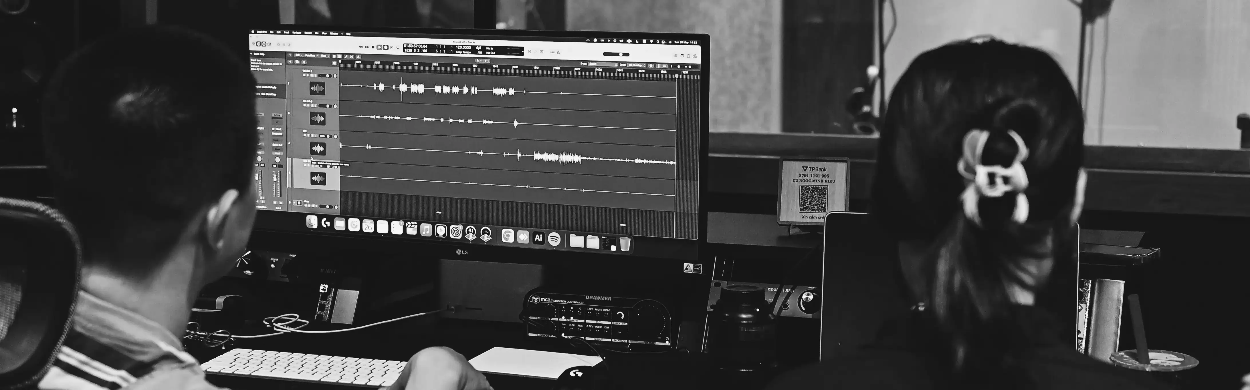 Two audio engineers monitoring a recording session at Méulo